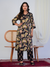 Woman wearing a black floral kurta with pants in a minimalistic setting